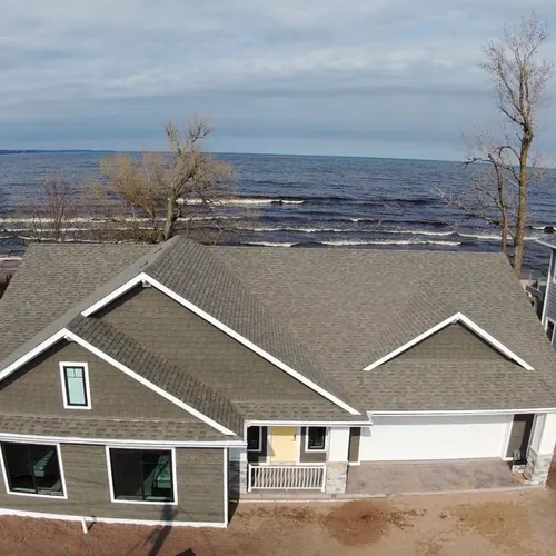 Aerial view of a Duluth home with a freshly installed roof
