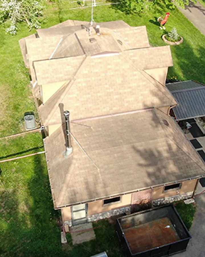 Aerial view of a completed roof replacement on a two-story Duluth home