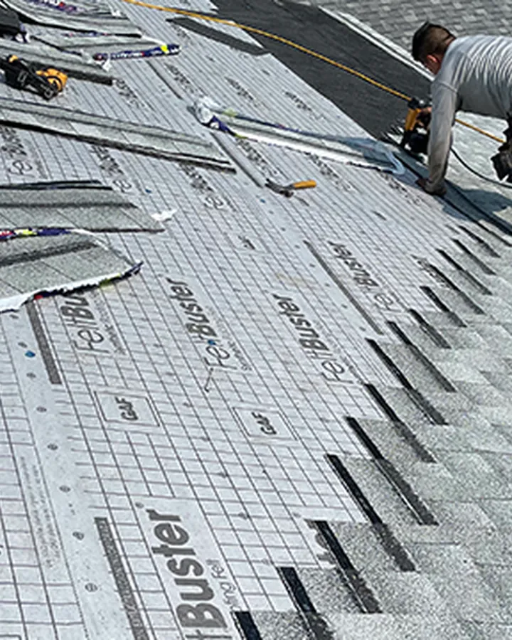Roofer fastening shingles over synthetic underlayment
