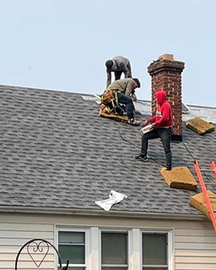 Rhino Roofing crew on a residential roof near the eaves